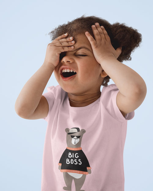 girl with curly hair wearing pink cheeky chappy kids tshirt with bear print face palm