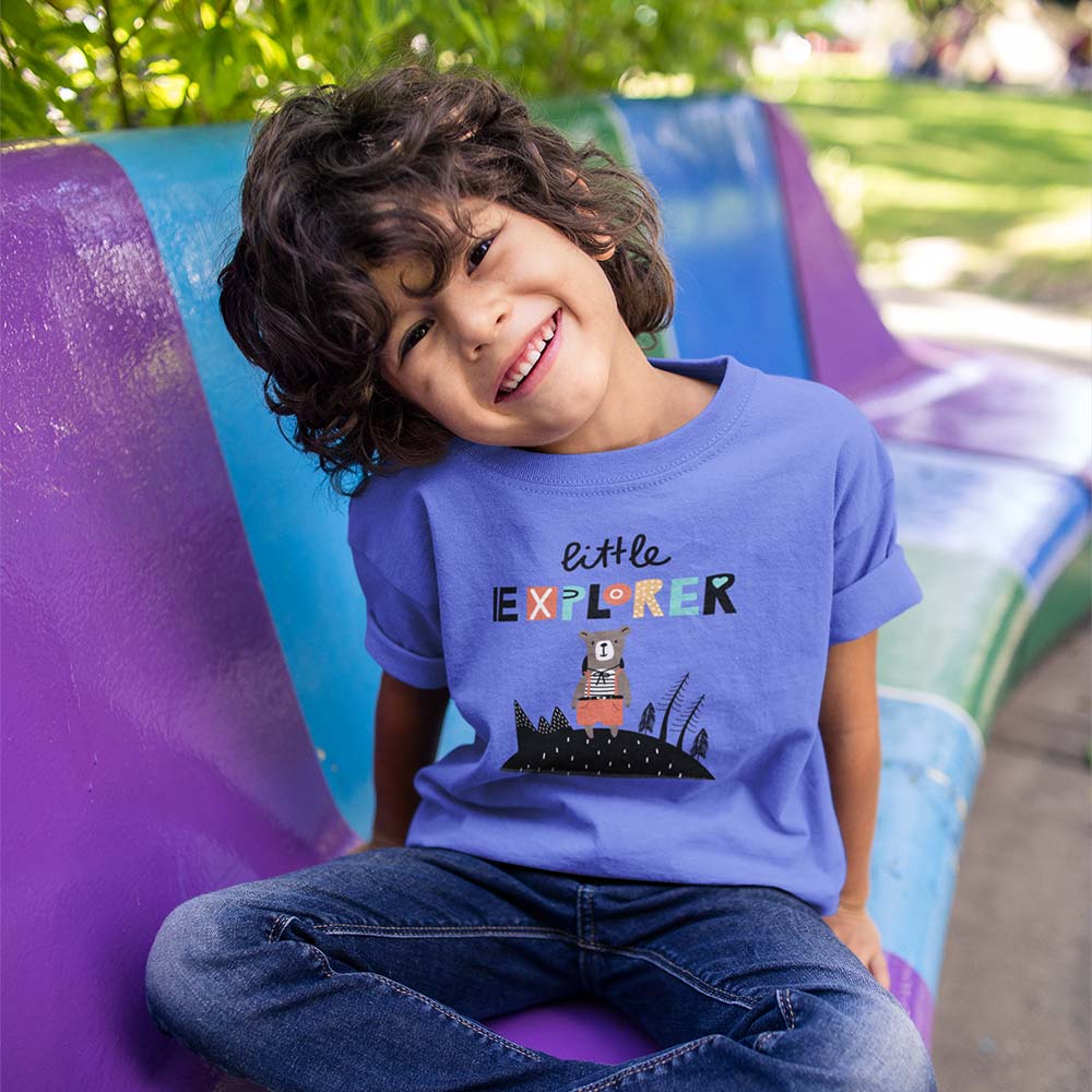 boy-sitting-on-a-bench-wearing-a-tshirt-template-while-smiling-a17864-(1) boy sitting on a bench wearing a tshirt template while smiling a17864 1