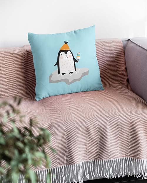 mockup of a squared pillow on a relaxing couch penguin icecream print