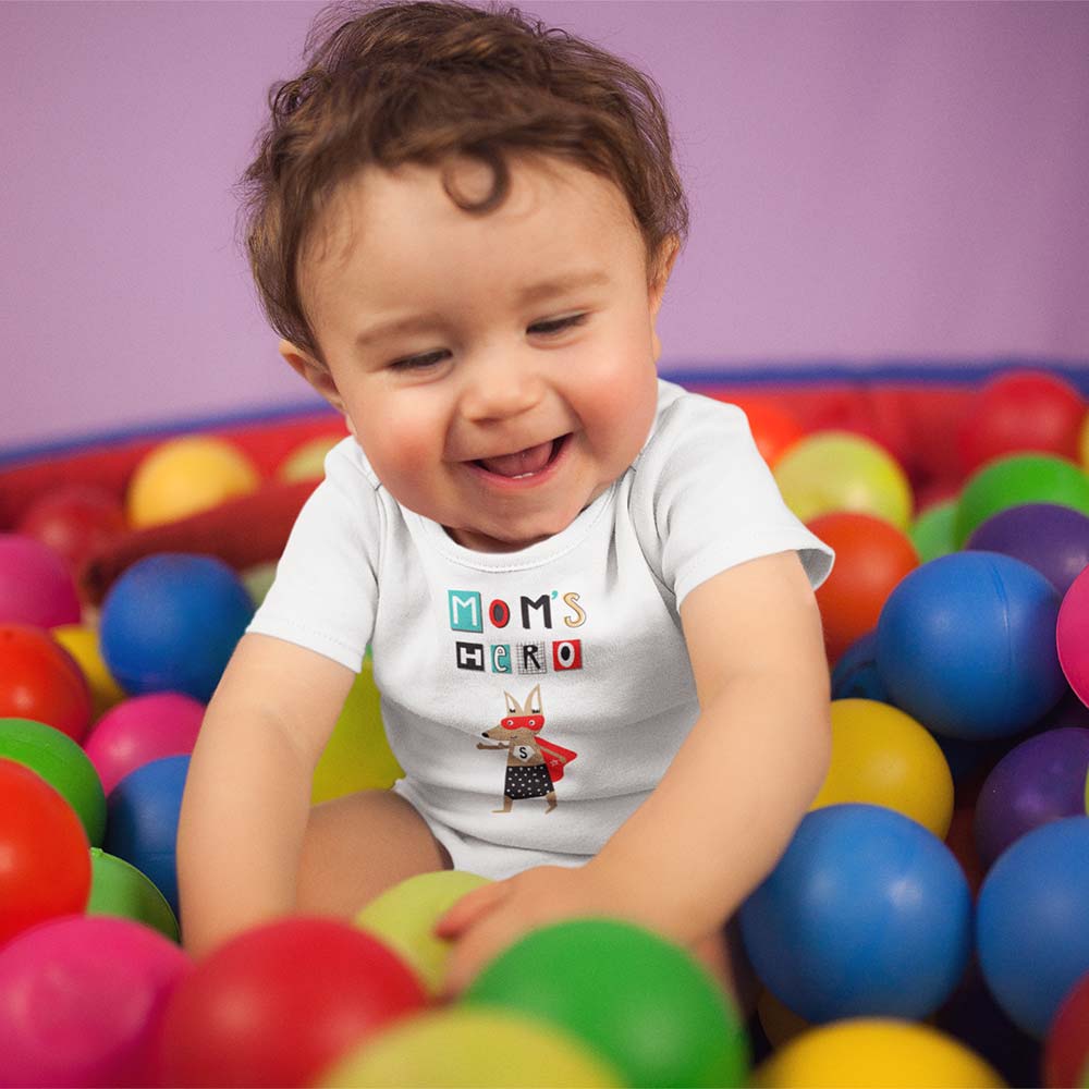 white-baby-boy-wearing-a-onesie-smiling-while-playing-in-the-ball-pit-mockup-14026 white baby boy wearing a onesie smiling while playing in the ball pit mockup 14026